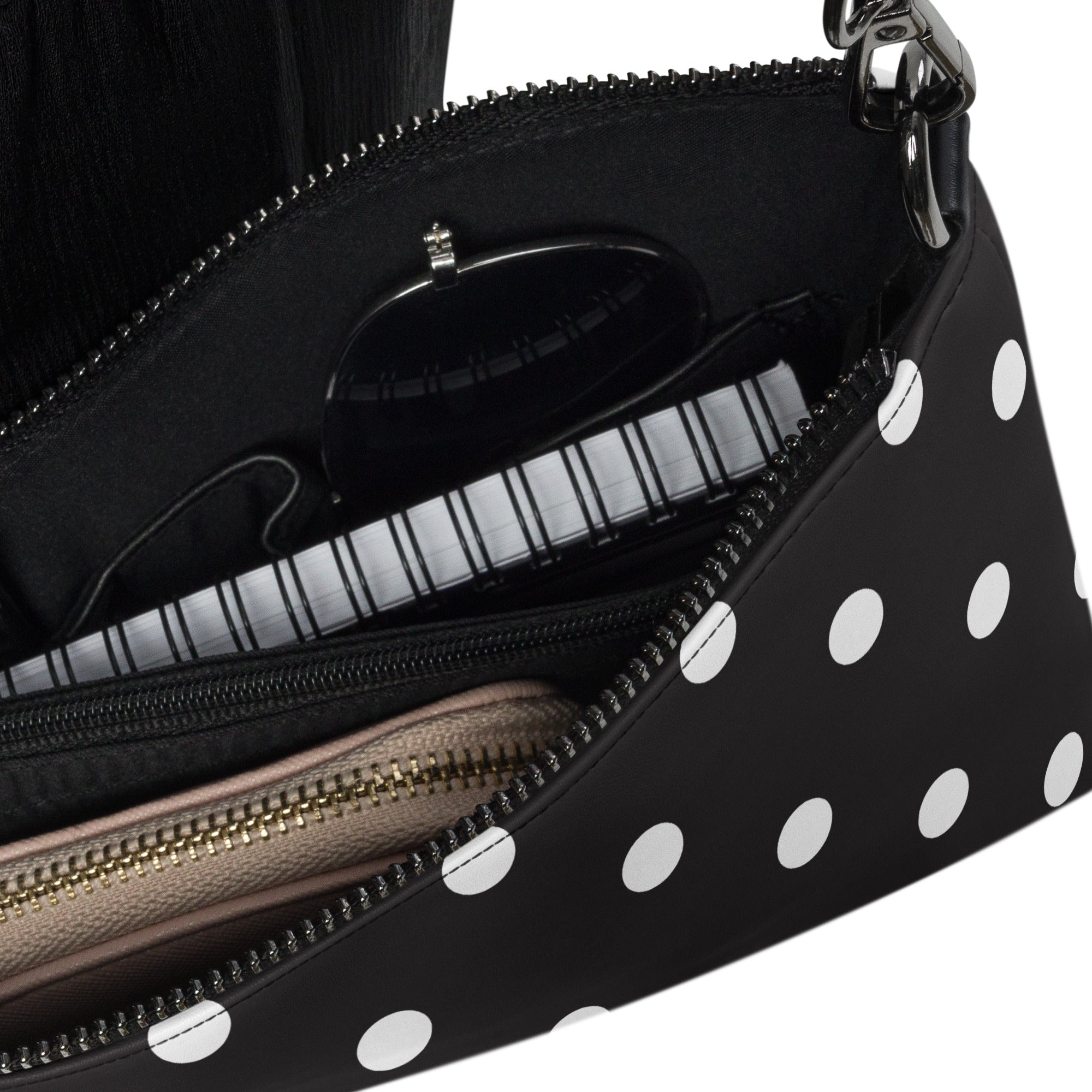 Interior detail of crossbody bag with white polka dots