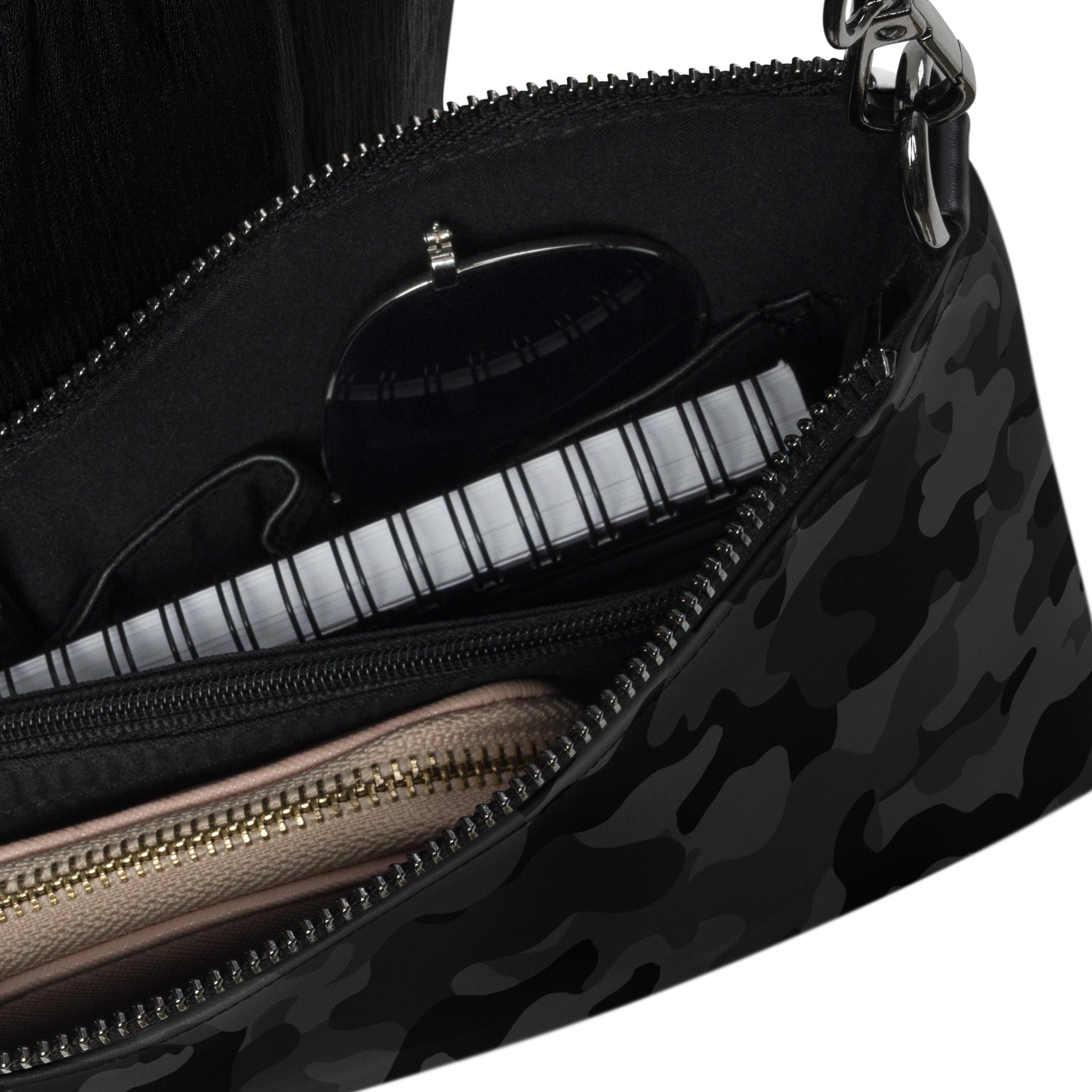 A black and gray camouflage patterned crossbody bag interior detail