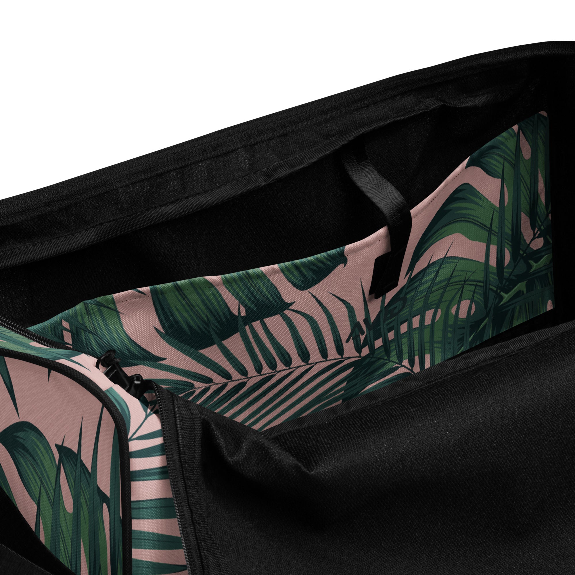 Duffle bag with tropical leaf pattern and black straps