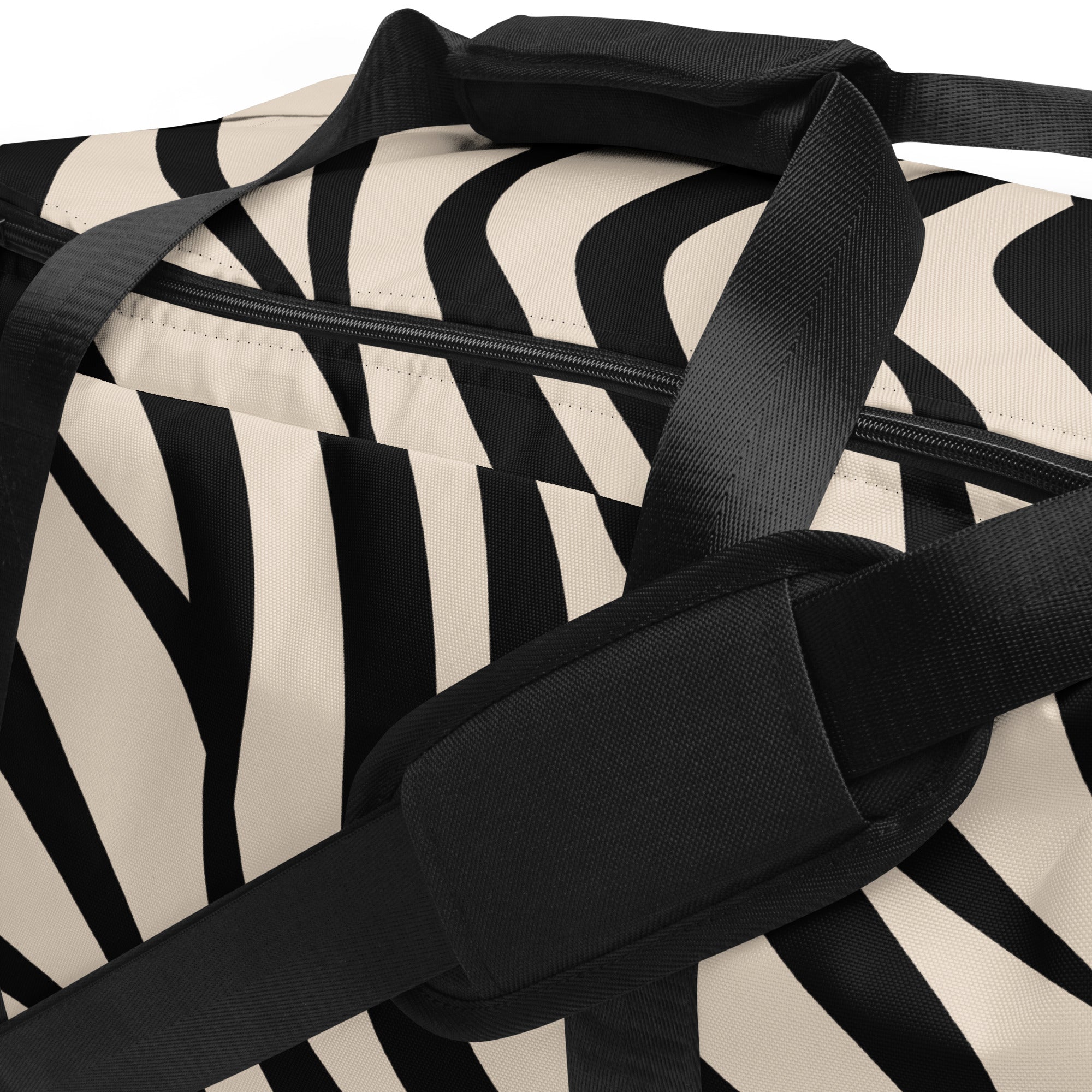 Close-up of a black and white zebra print duffle bag with focus on the straps and handles.