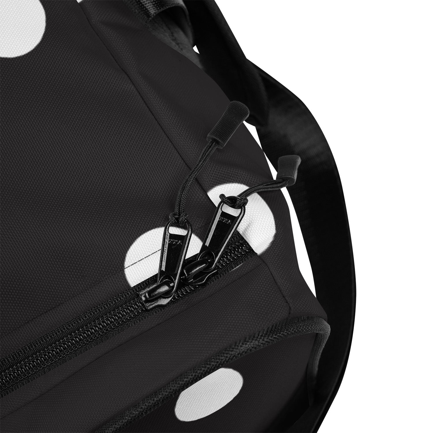Black backpack with white polka dots and a visible brand logo on a white background