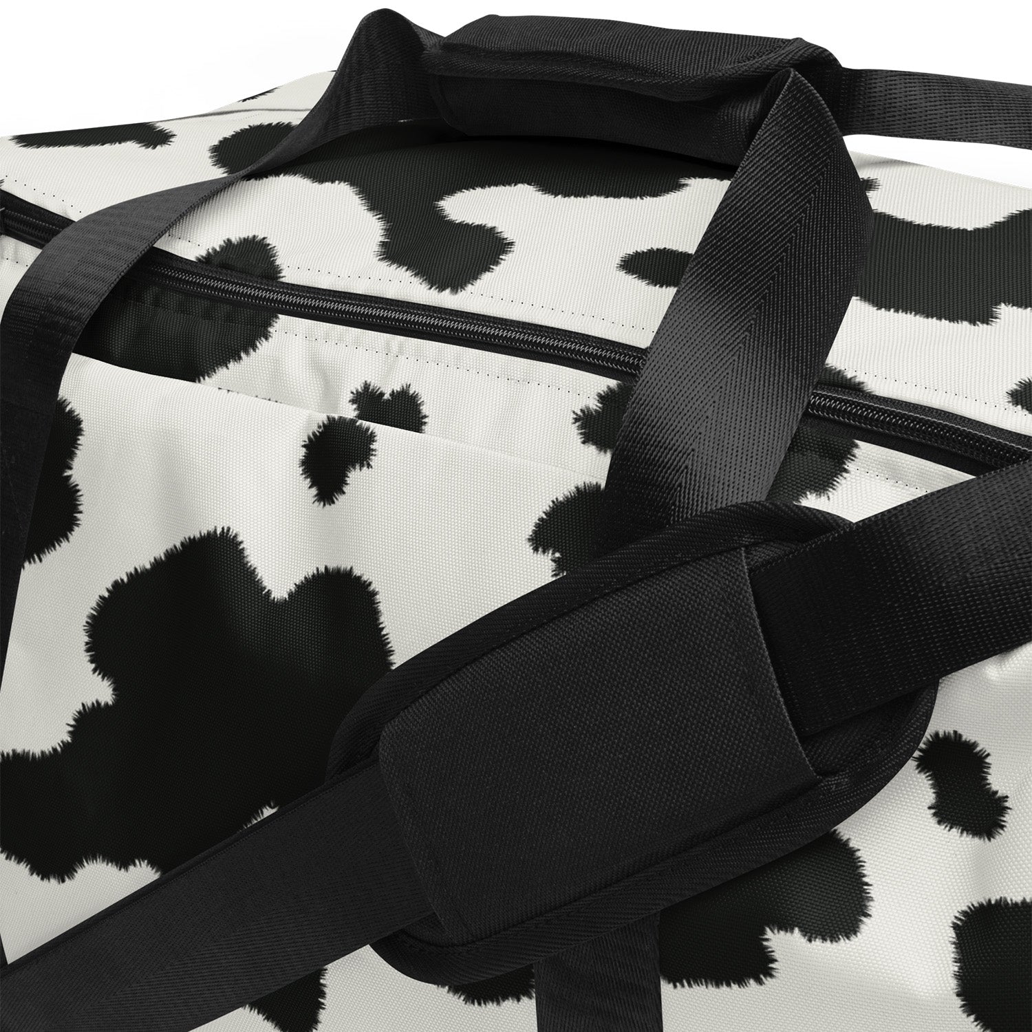 Black and white duffel bag with a cow print pattern
