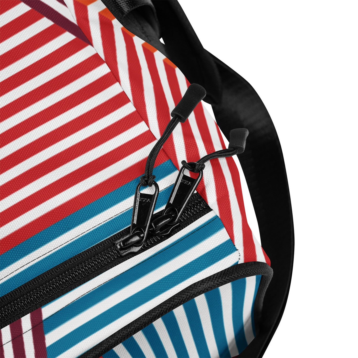 Close-up of a striped bag with a black zipper and strap.