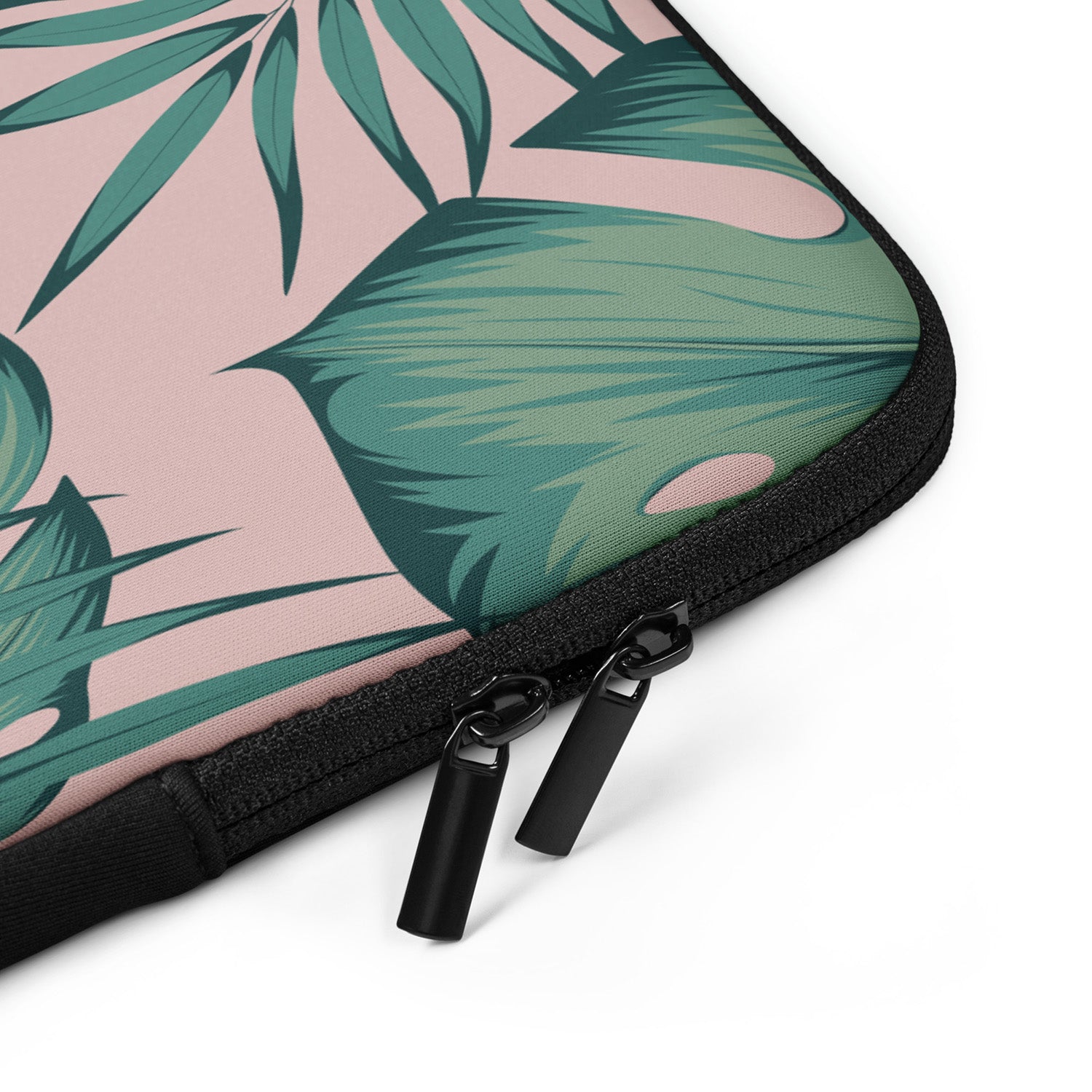 Laptop sleeve with tropical leaf pattern and zipper on a white background