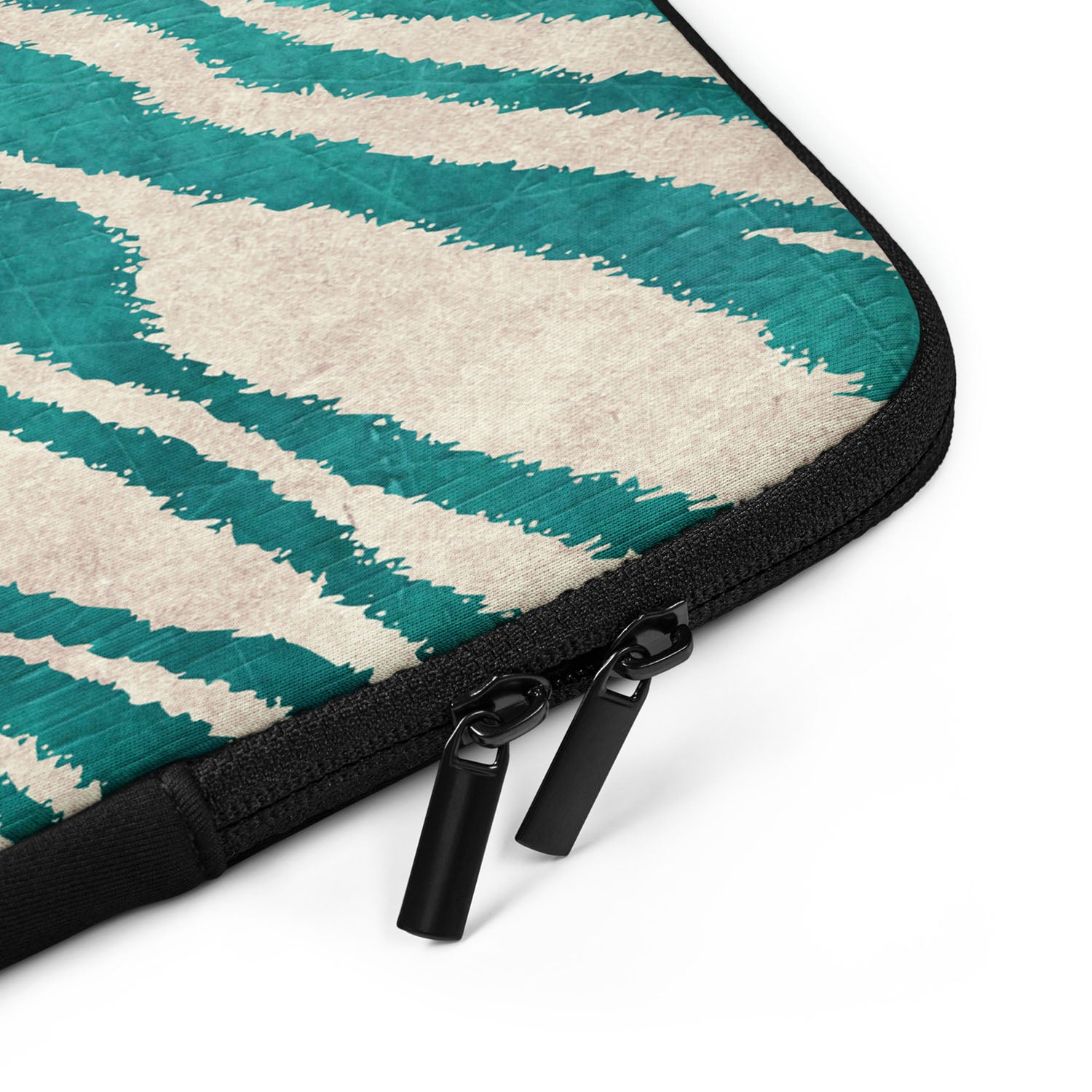 Close-up of a teal and beige patterned laptop sleeve with a black zipper on a white background