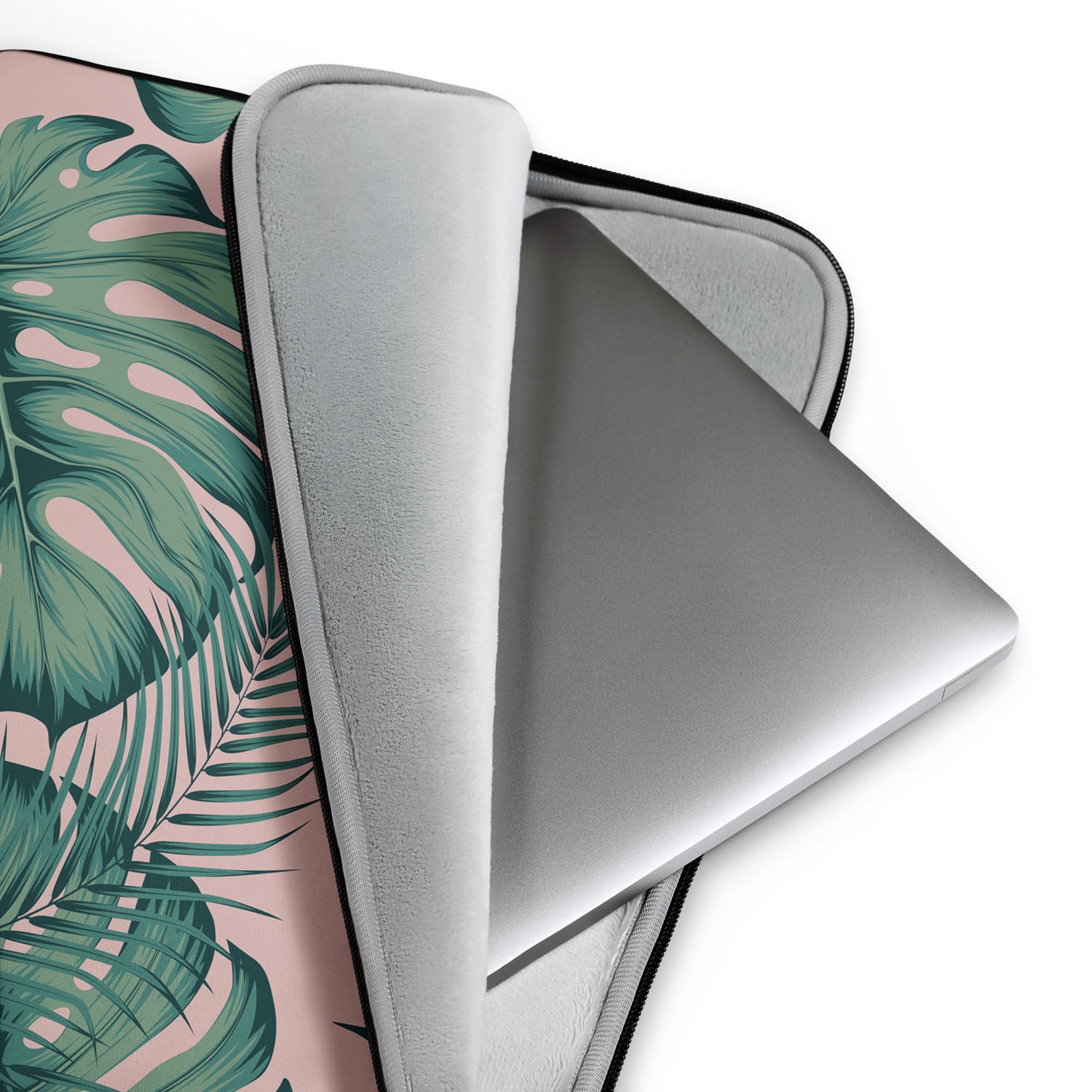 Laptop with a tropical leaf patterned sleeve on a white background