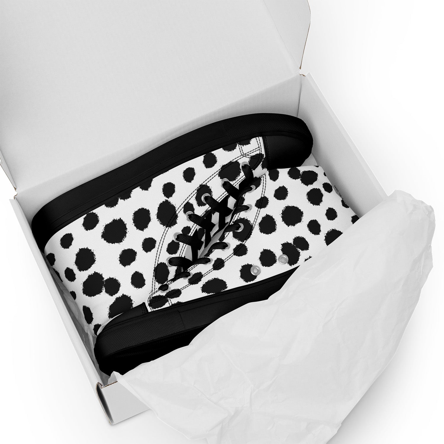 Black and white polka dot sneaker in a white box on a white background