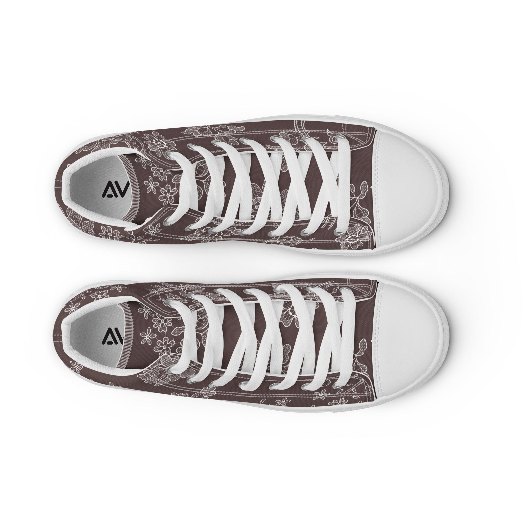 Pair of brown sneakers with white floral patterns and white laces on a white background