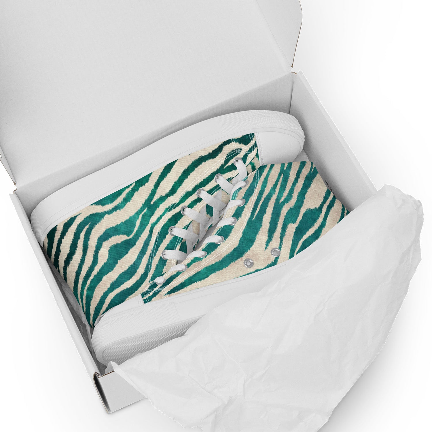 Teal and beige patterned pillow in a white box on a white background