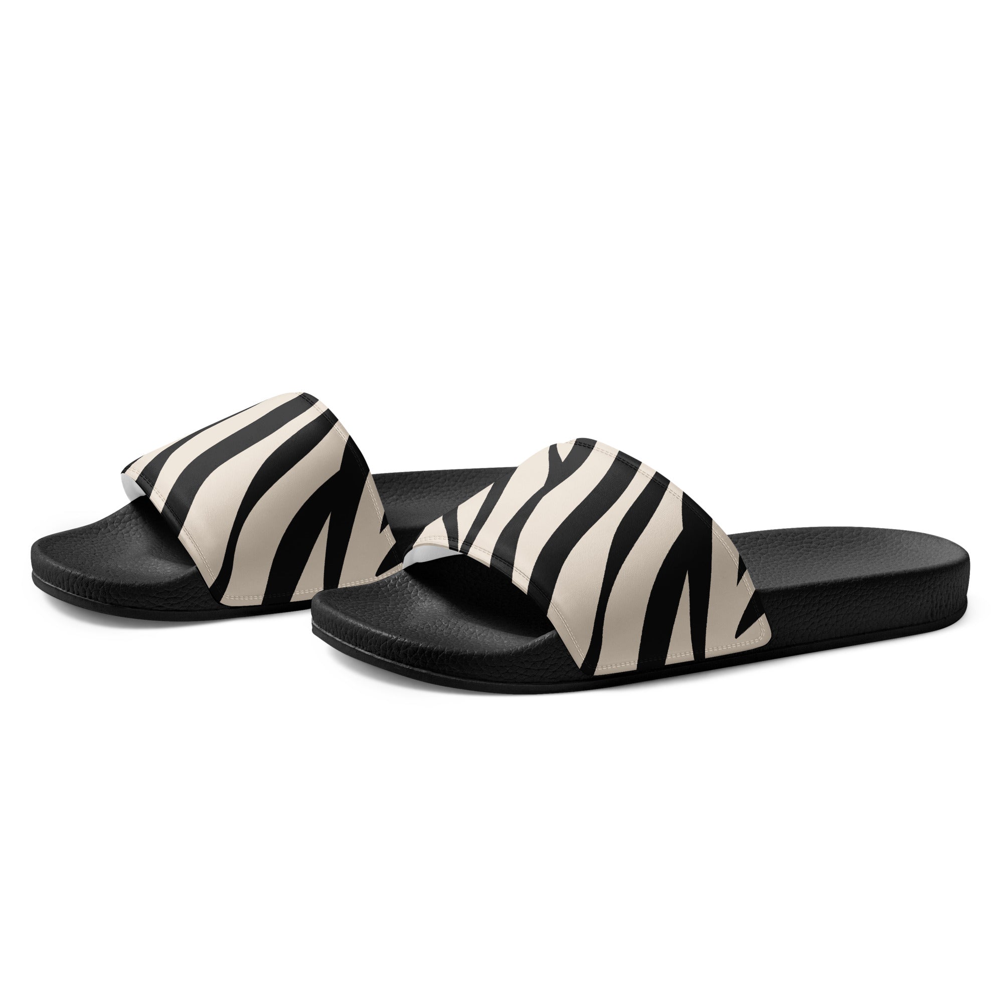 Pair of black and white zebra-striped slides with black soles