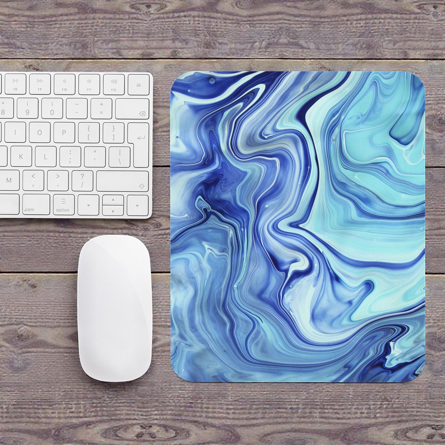 Blue and white marbled mouse pad on a wooden desk with a keyboard and mouse.