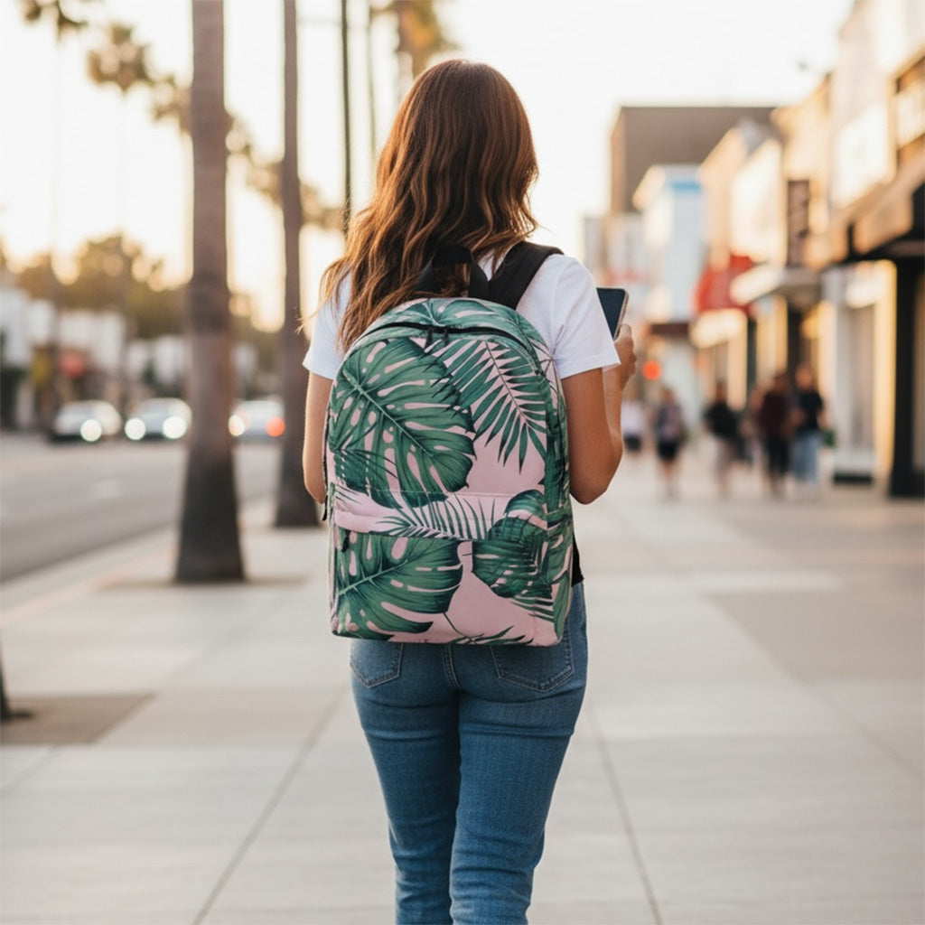 Person walking on a sidewalk with a tropical leaf-patterned backpack