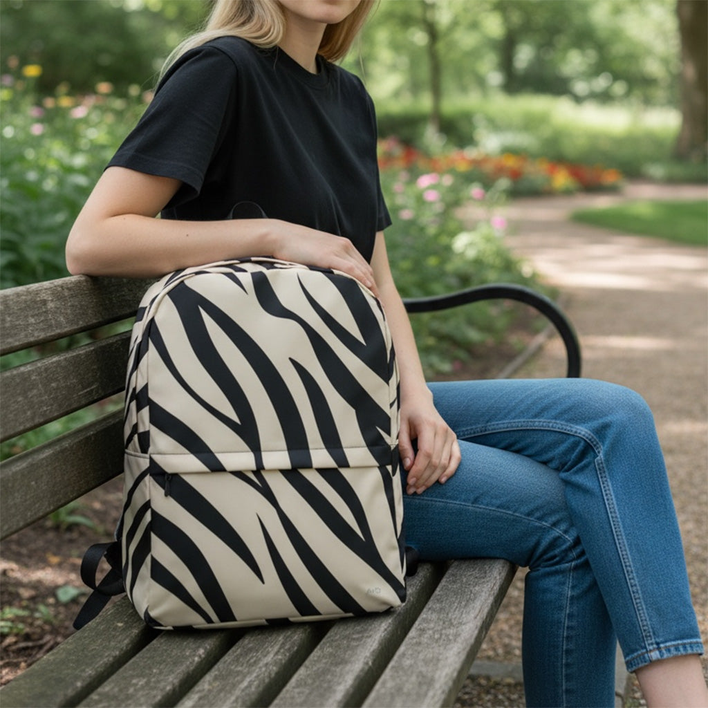 Person sitting on a bench with a zebra-striped backpack