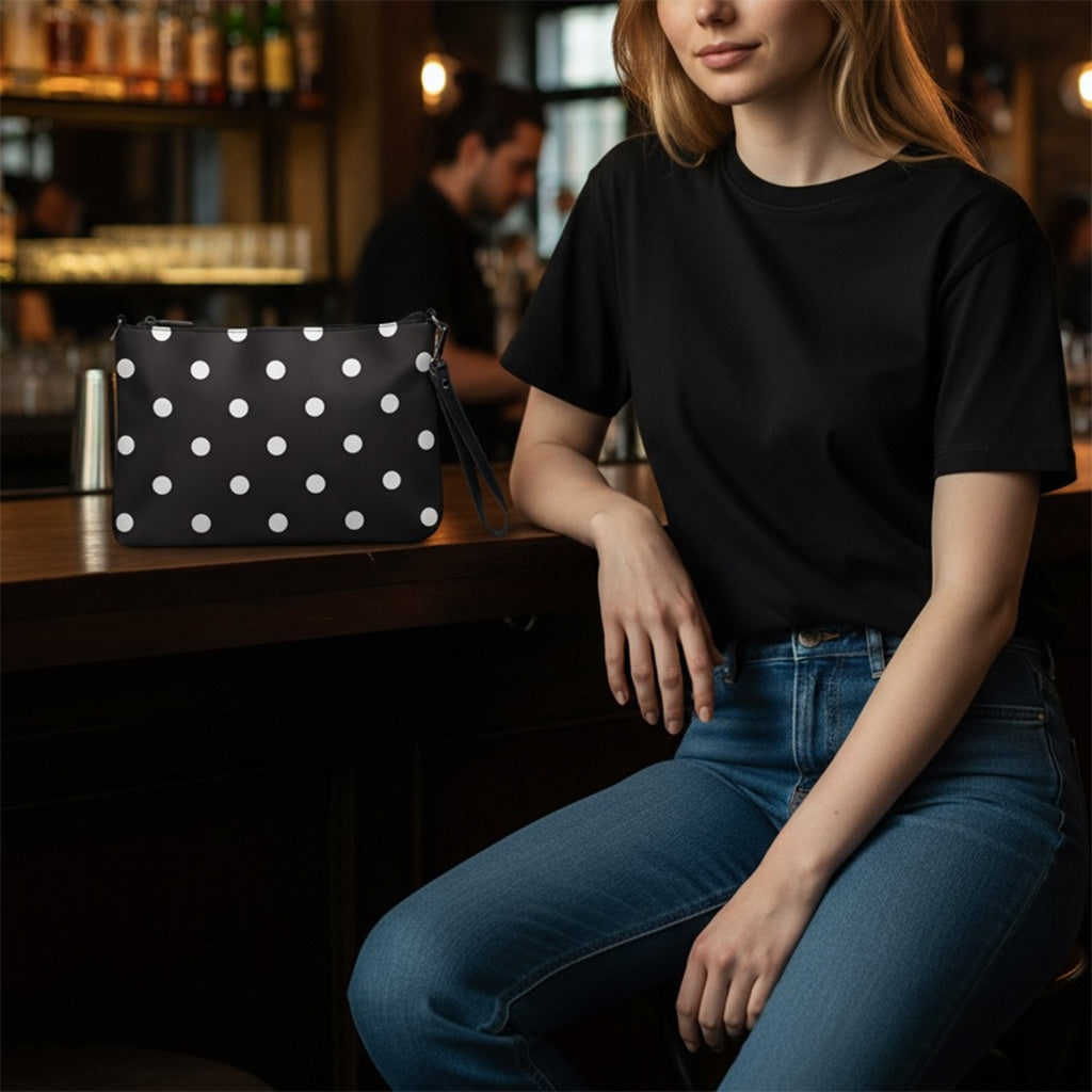 Woman sitting at a bar with a polka dot bag on the counter