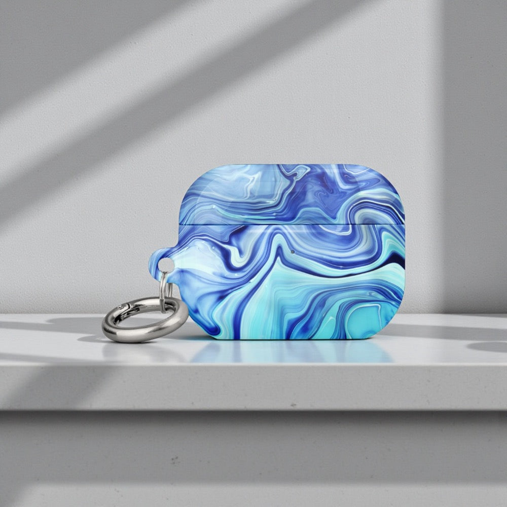 Blue and white marbled keychain on a gray surface with a light gray background