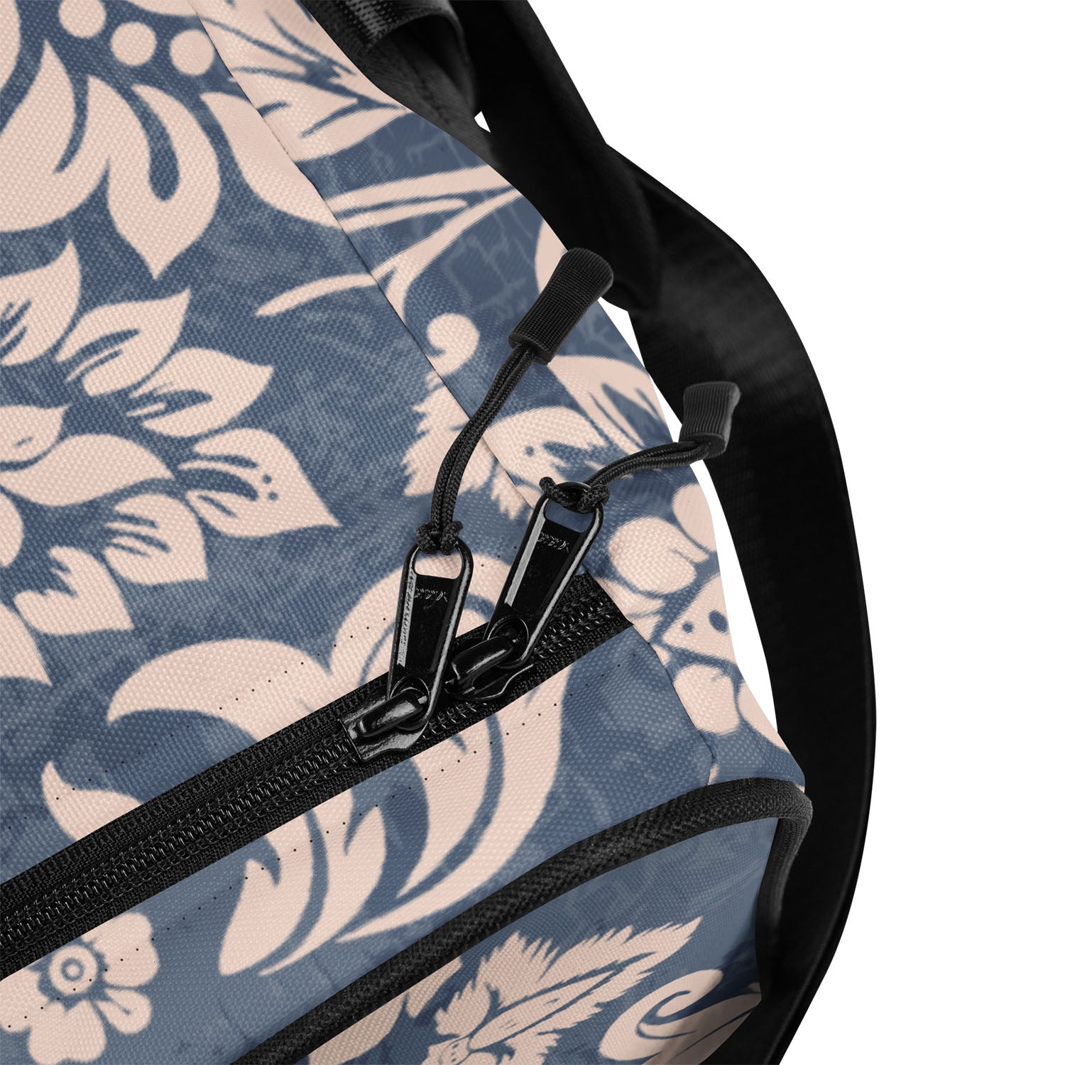 Close-up of a floral-patterned bag with a zipper and strap.