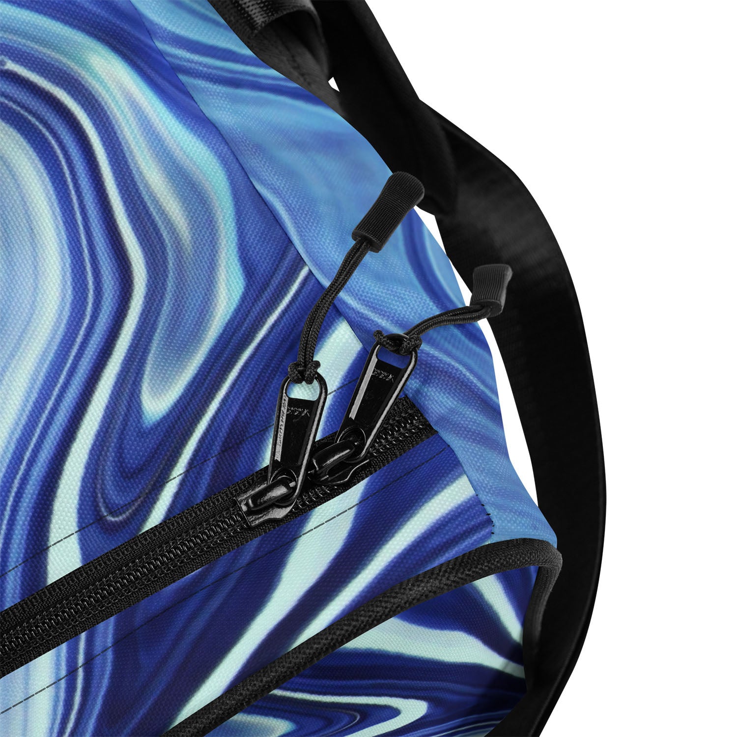 Close-up of a blue and black patterned bag with a zipper and strap.