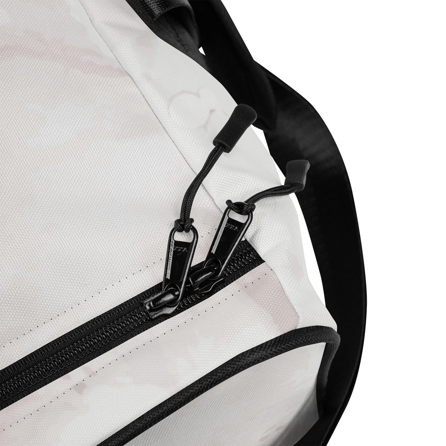Close-up of a marble print duffel with black zippers and straps on a white background