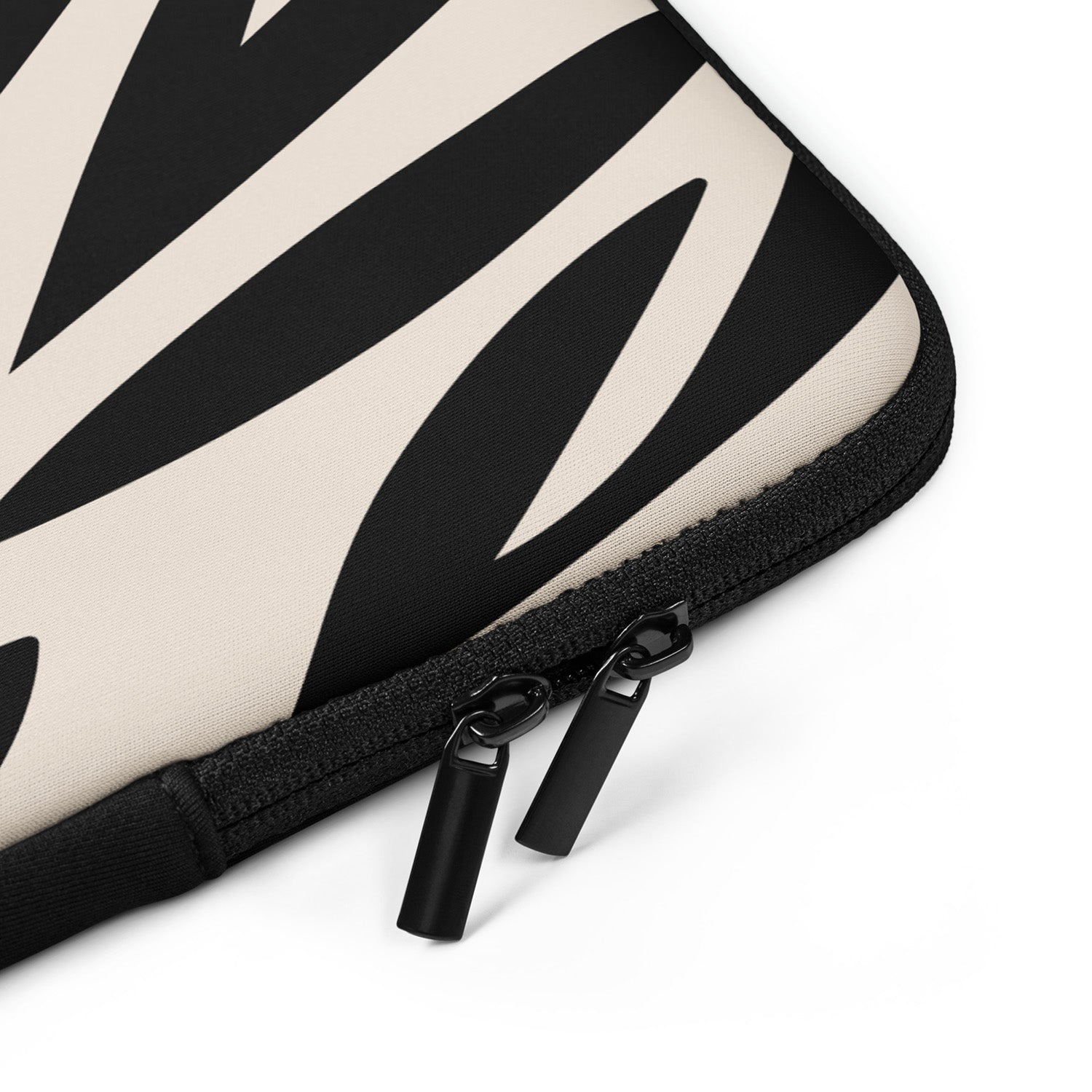 Black and white patterned laptop sleeve with a zipper on a white background