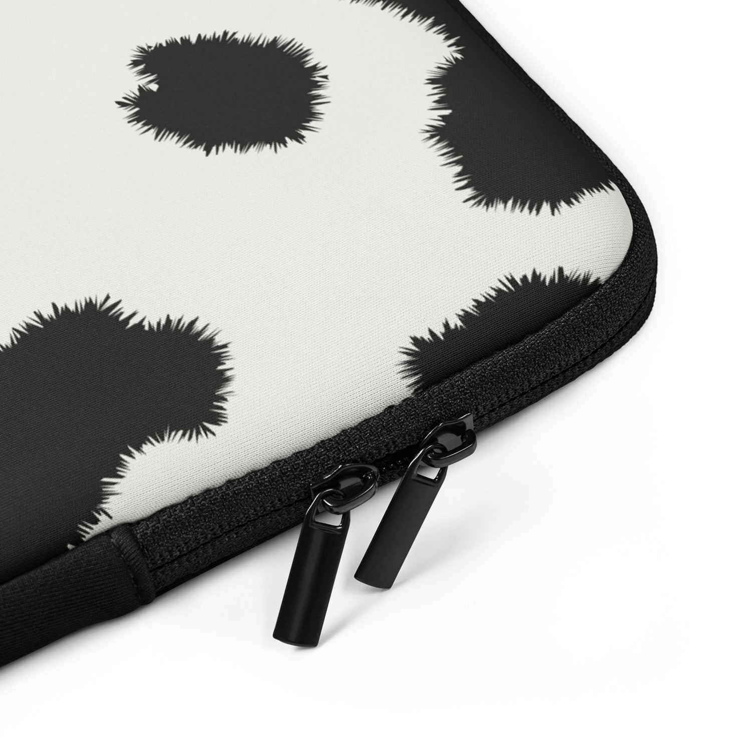 Black and white patterned laptop sleeve with zipper on a white background