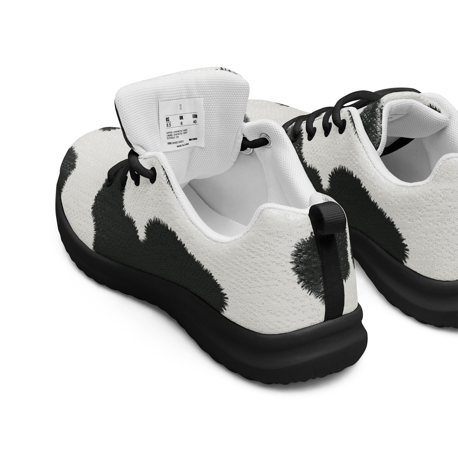 Black and white sneakers with a cow print pattern on a white background