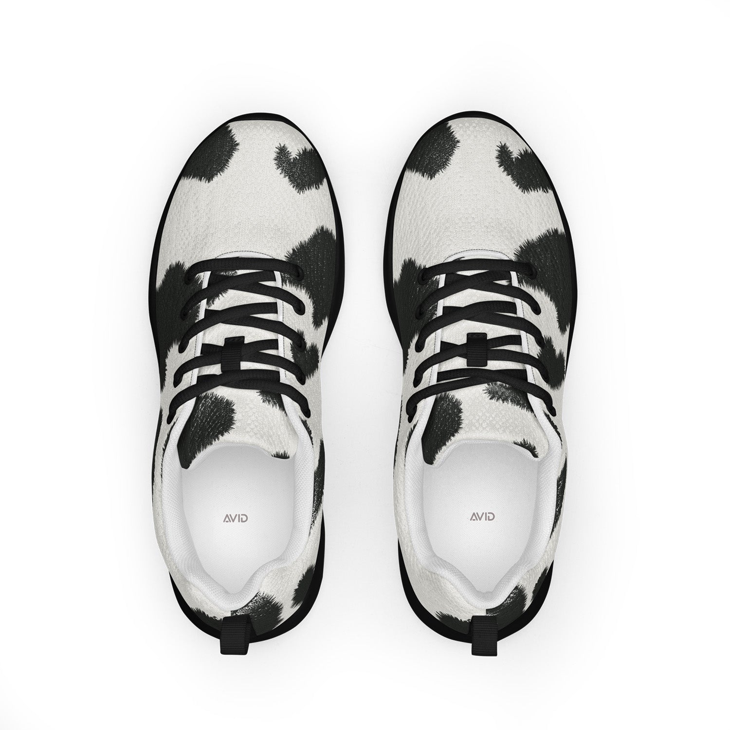 Black and white cow print sneakers on a white background