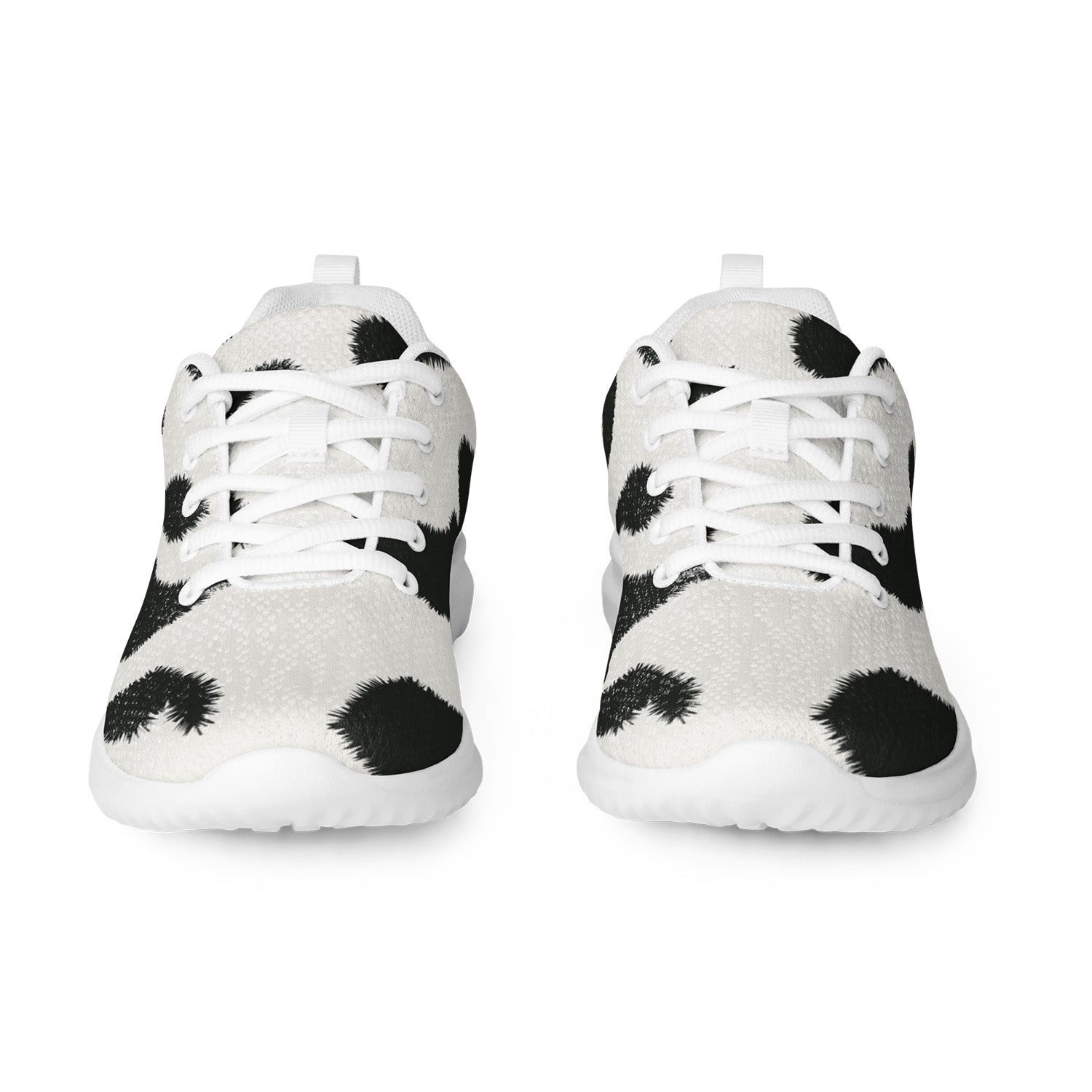 White sneakers with black cow print pattern on a white background