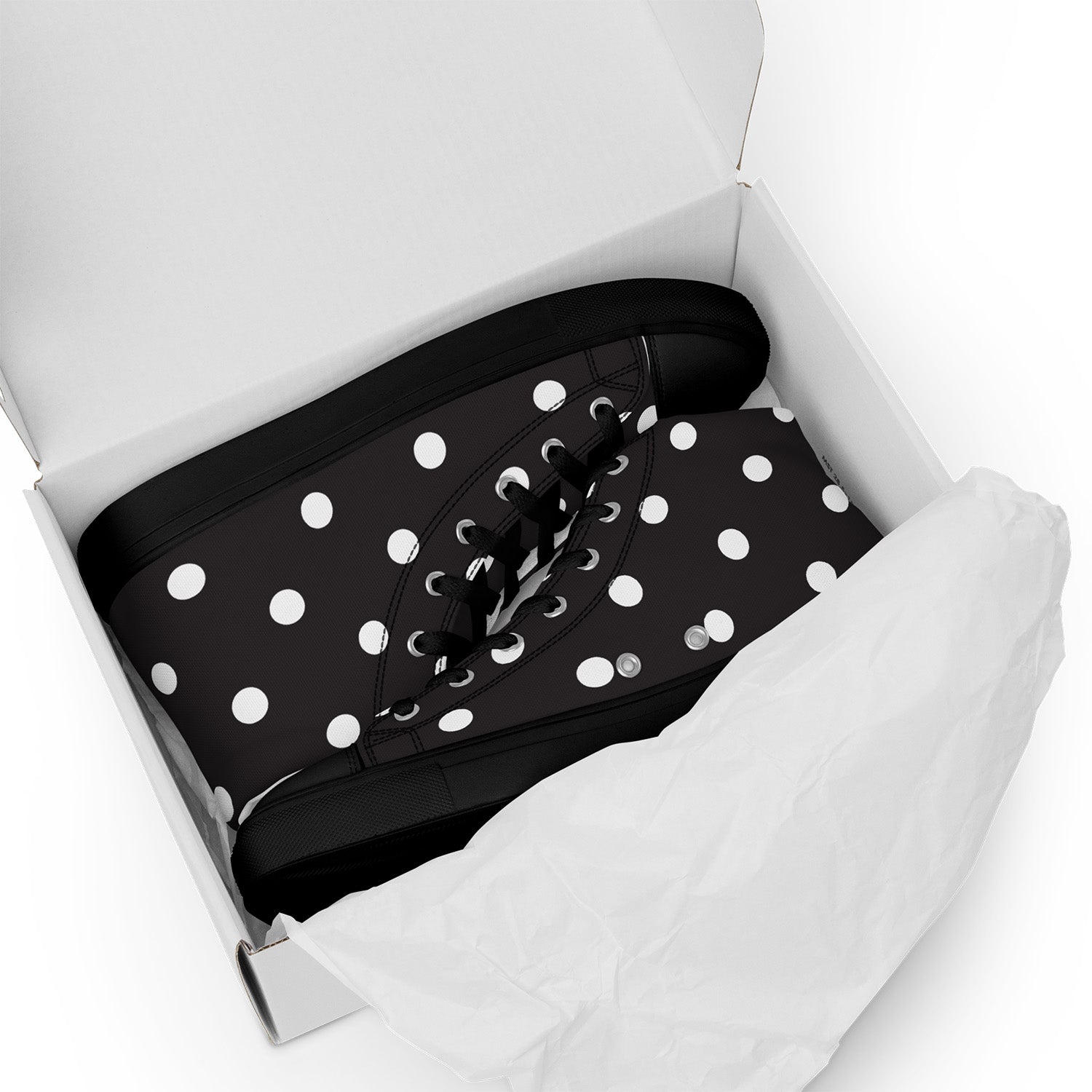 Black shoe with white polka dots in a white box on a white background